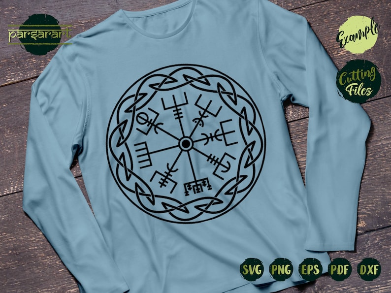 May include: A light blue long-sleeved t-shirt with a black and white compass design. The compass is surrounded by a Celtic knot design.
