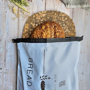 May include: A light blue bread bag with a black drawstring and a logo that says "New Living Bread Bag".