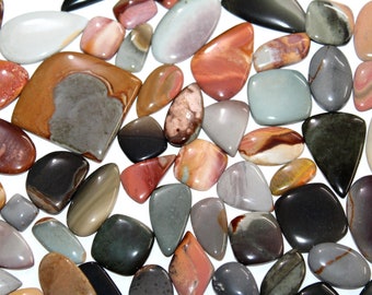 May include: A collection of polished, colorful, and patterned stones. The stones are various shapes and sizes, including oval, round, and rectangular. The stones are a mix of brown, red, gray, and white.