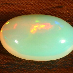 Ethiopian Opal Oval Shape Size, 18x11x8 MM. 7.15 Crt. Red Opal Fire Play Fire Multi Appariscente Ethiopian Opal Loose Gemstone.