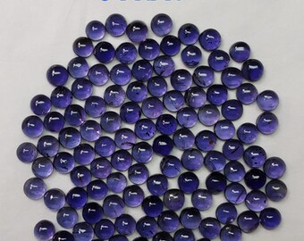 May include: A pile of 3 mm round, purple amethyst cabochons. The cabochons are smooth and have a slight sheen.