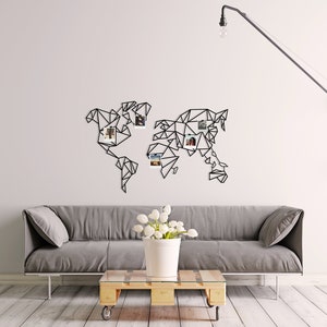 May include: A black metal world map wall decor with a geometric design. The map has a white background and is decorated with small photos.