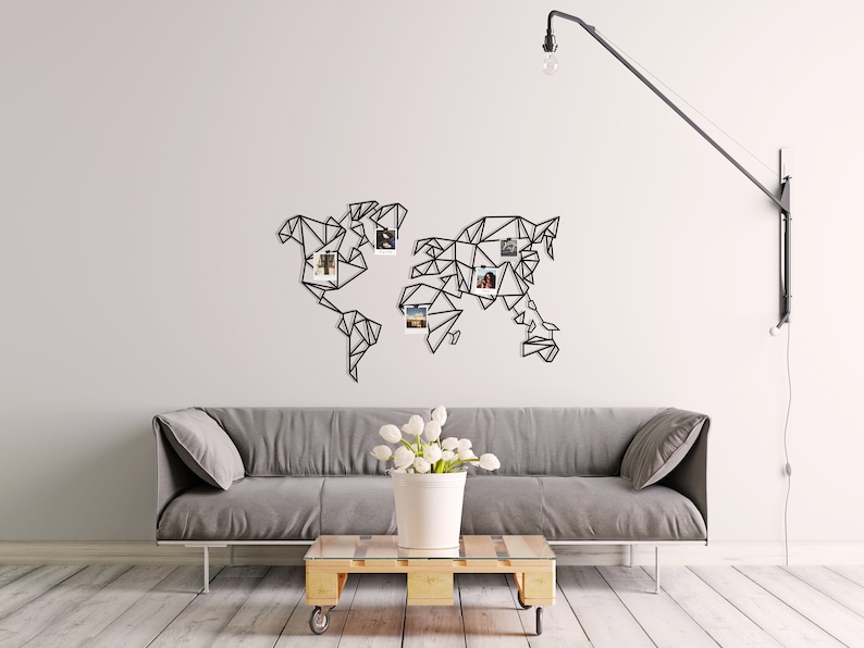 May include: A black metal world map wall decor with a geometric design. The map has a white background and is decorated with small photos.