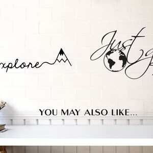 May include: Black and white wall decal with the text "Just go" and a globe with an airplane. The text "explore" is written with a mountain range next to it. The text "YOU MAY ALSO LIKE..." is written below the decals.