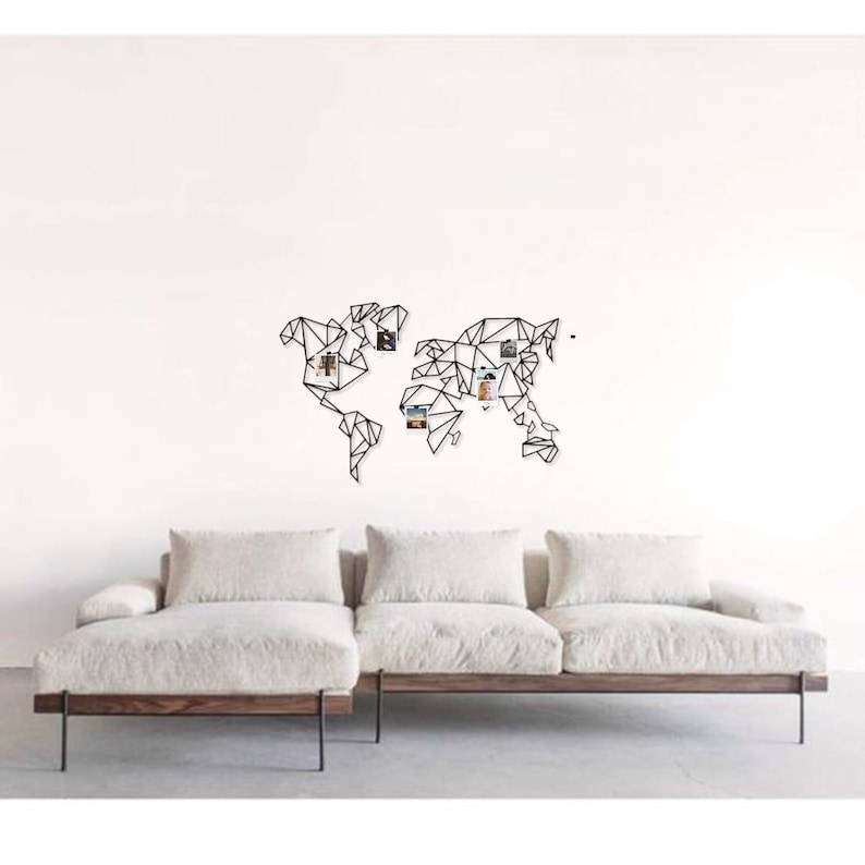 May include: Black metal world map wall decor with a geometric design. The map is decorated with small photos.