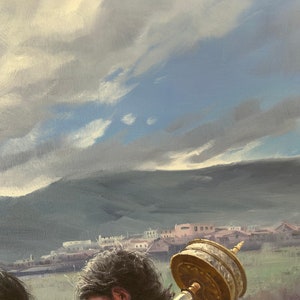 May include: A person with long dark hair is carrying a large, golden prayer wheel. The wheel is decorated with intricate carvings and is set against a backdrop of a distant town and a cloudy sky.
