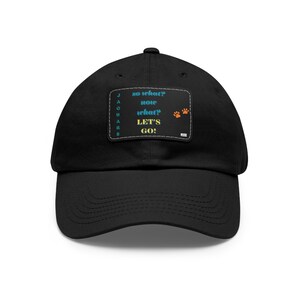 May include: Black baseball cap with a patch that says "so what? now what? LET'S GO!" with paw prints on the right side.