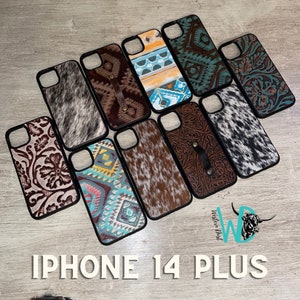 May include: A selection of iPhone 14 Plus phone cases featuring a range of designs. The cases showcase various patterns, including floral, geometric, and cowhide. All cases are black with a clear plastic back.