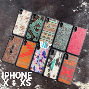 May include: Assortment of iPhone X & XS phone cases with various western-inspired designs. The cases feature a variety of colours and patterns, including cowhide, turquoise, red, and brown.