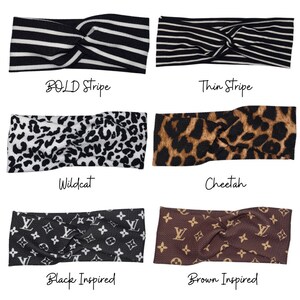 May include: Six different styles of knotted headbands. The headbands are made of fabric and feature various patterns, including stripes, cheetah print, and a black and white wildcat print. The headbands are labeled with their names: Bold Stripe, Thin Stripe, Wildcat, Cheetah, Black Inspired, and Brown Inspired.