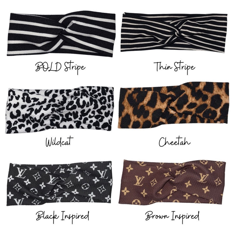 May include: Six different styles of knotted headbands. The headbands are made of fabric and feature various patterns, including stripes, cheetah print, and a black and white wildcat print. The headbands are labeled with their names: Bold Stripe, Thin Stripe, Wildcat, Cheetah, Black Inspired, and Brown Inspired.