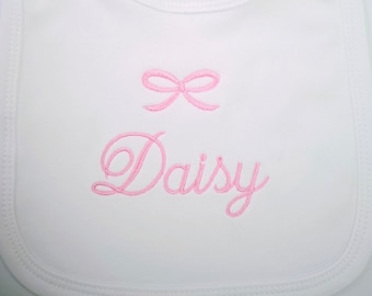 New personalized embroidered baby girl white cotton bib name with a bow.