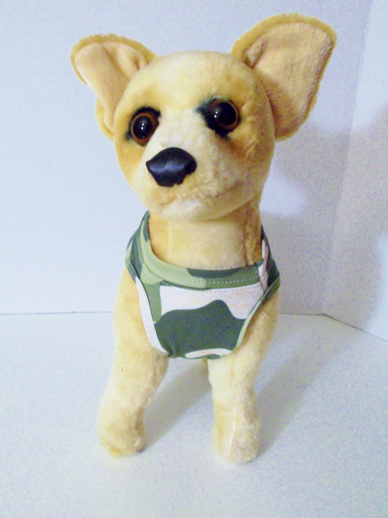 May include: A plush toy chihuahua wearing a green and white camouflage print dog vest.