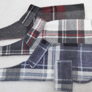 May include: Three plaid dog sweaters in different color combinations. The sweaters are made of a soft, fleece-like material and have a simple, classic design.