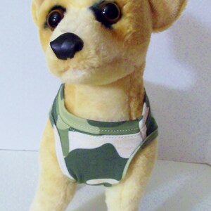 May include: A plush toy chihuahua wearing a green and white camouflage dog vest.