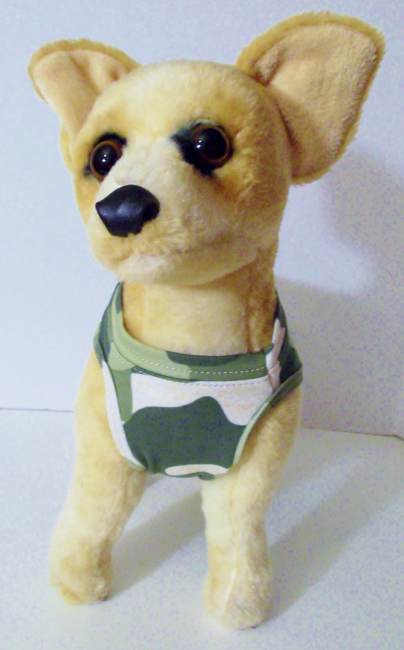 May include: A plush toy chihuahua wearing a green and white camouflage dog vest.
