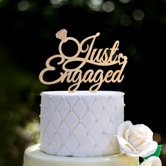 Mountain climbing couple cake with engagement ring