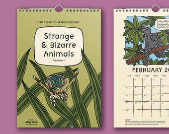 May include: A 2027 illustrated wall calendar titled Strange & Bizarre Animals Volume 1, featuring a colorful spider on the cover and a February page with a Long-Wattled Umbrellabird illustration, both bound with a silver metal spiral wire.