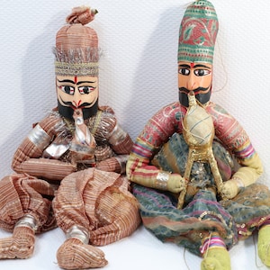 Two dolls playing double flute