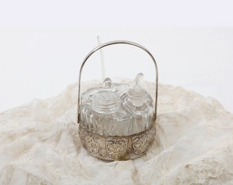 Glass salt, pepper and mustard set in a silver-plated holder with handle