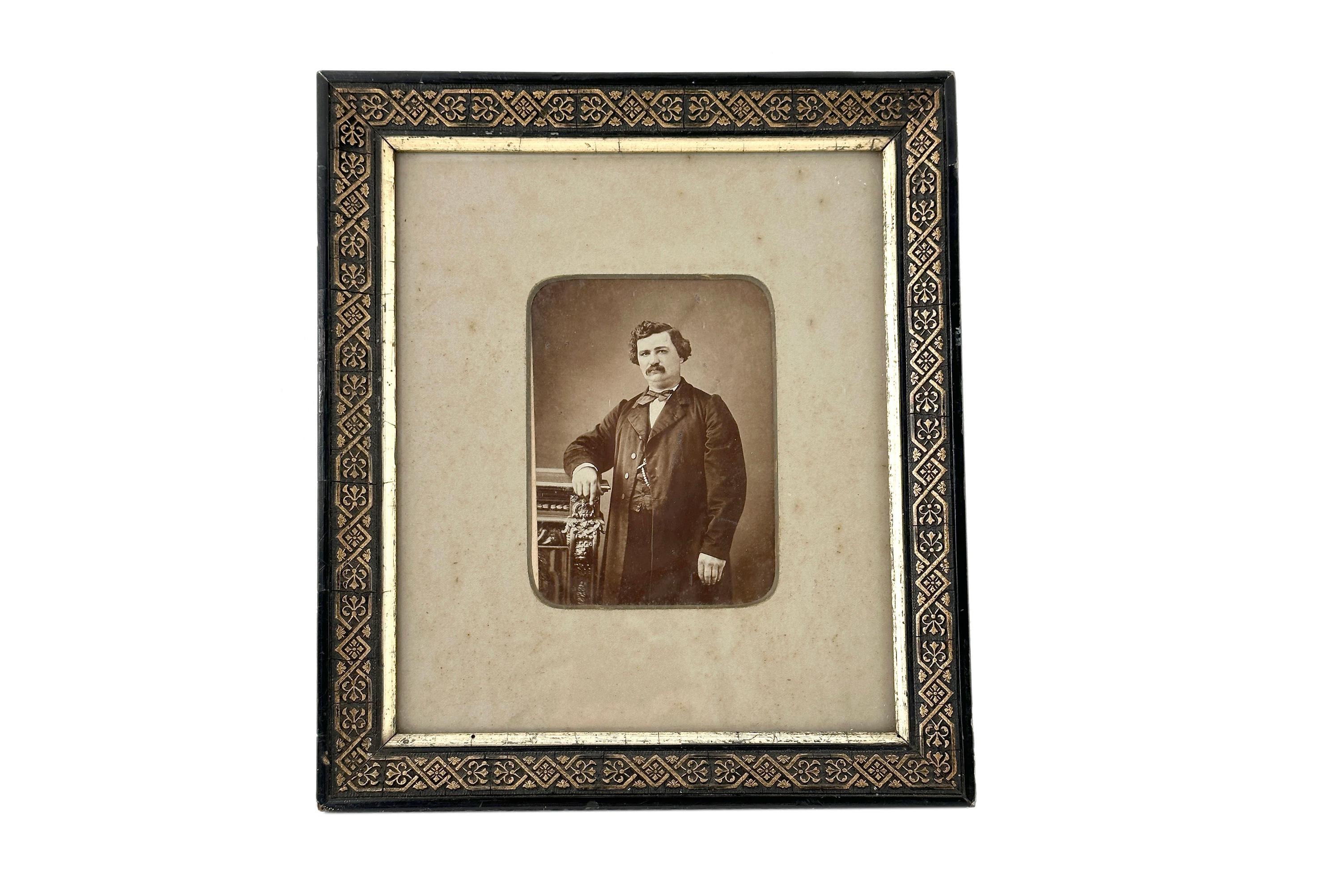 Antique Photo of a neat man with a moustache in a gold black wooden frame