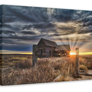 Last Rays of the Sunset from behind an abandoned farm house on the prairie.