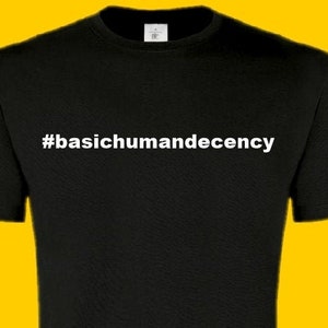 May include: Black t-shirt with white text that reads "#basichumandecency".