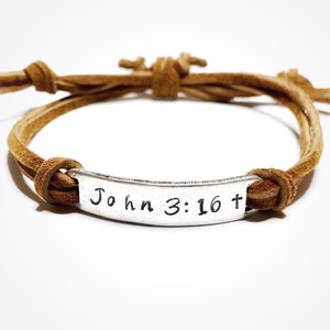 May include: A brown leather bracelet with a silver charm that says "John 3:16+"