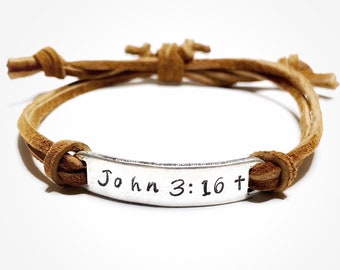 May include: A brown leather bracelet with a silver charm that says "John 3:16+"
