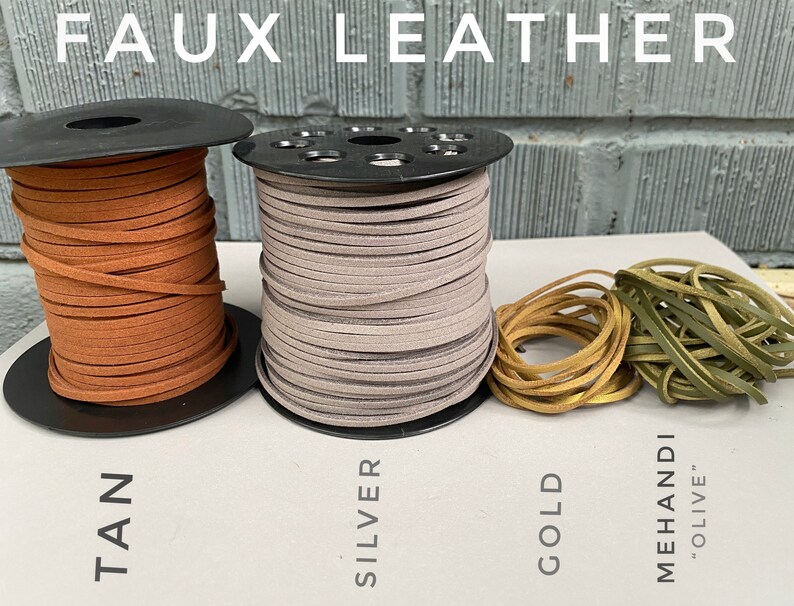 May include: Four spools of faux leather cord in tan, silver, gold, and olive green. The cords are wound around black spools and labeled with their colors.