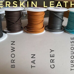 May include: Five spools of deerskin leather cord in black, brown, tan, gray, and turquoise. The spools are labeled with the color names.