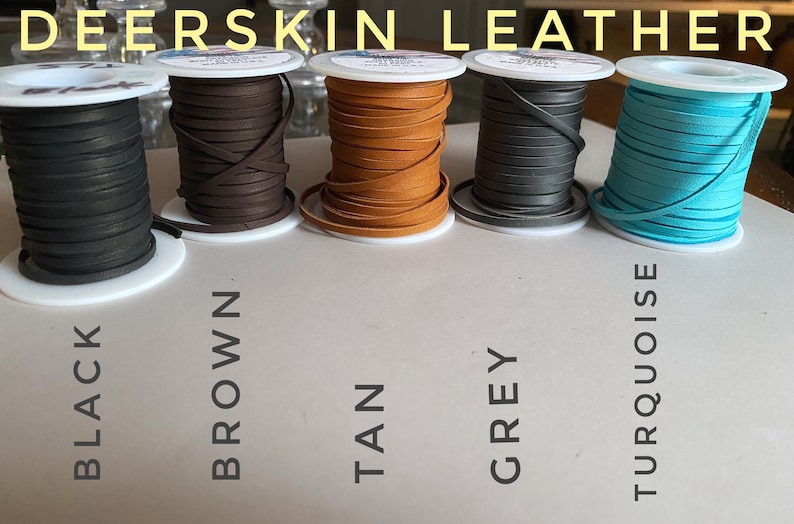 May include: Five spools of deerskin leather cord in black, brown, tan, gray, and turquoise. The spools are labeled with the color names.