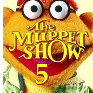 May include: A fuzzy orange Muppet character with red hair and black-rimmed glasses wearing a green jacket. The text "The Muppet Show 5" is displayed in yellow letters over the character, with "SEASON FIVE" printed in white on an orange bar below.