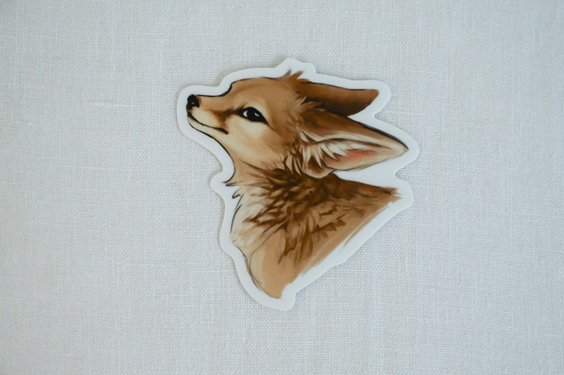 May include: A sticker featuring a detailed illustration of a fox's head, looking up with a curious expression. The fox has brown fur with lighter accents, and its ears are perked up.