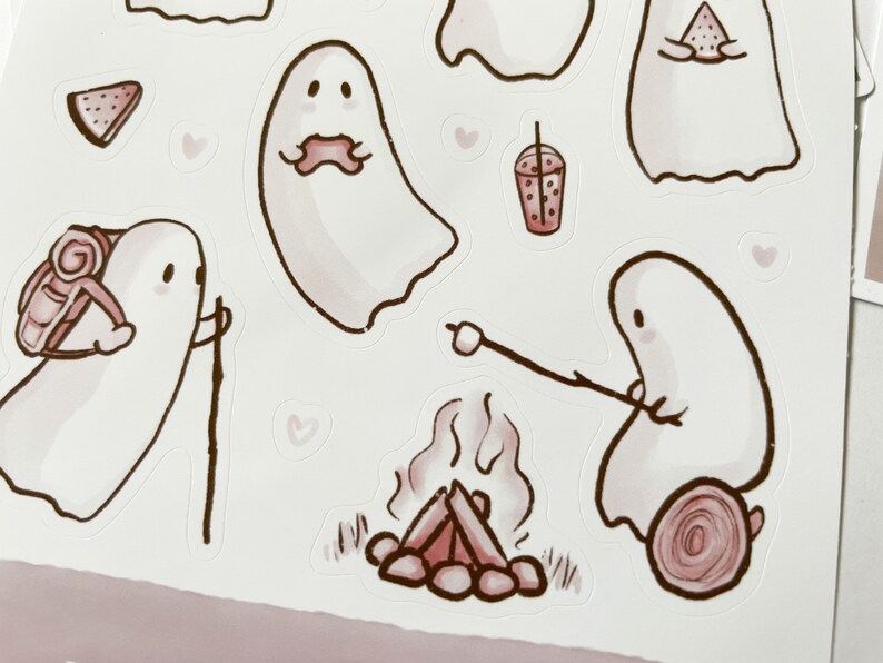May include: A set of cute ghost stickers with different activities, including hiking, eating watermelon, roasting marshmallows, and drinking boba tea. The stickers are in a watercolor style with pink and brown accents.