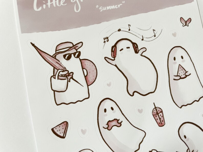 May include: A set of stickers featuring cute ghost illustrations in various summer activities, including listening to music, eating watermelon, and holding an umbrella. The stickers are in a pink and white color scheme with the text "Little ghosts" and "Summer" on the sheet.