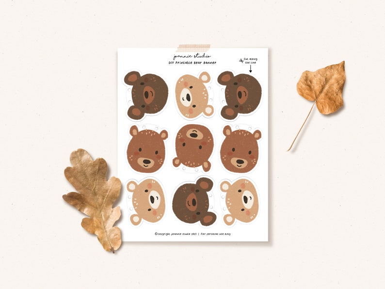 May include: Printable bear head cutouts for a DIY banner. The bear faces are brown, tan, and cream with black eyes and noses. The text on the page reads "DIY Printable Bear Banner".