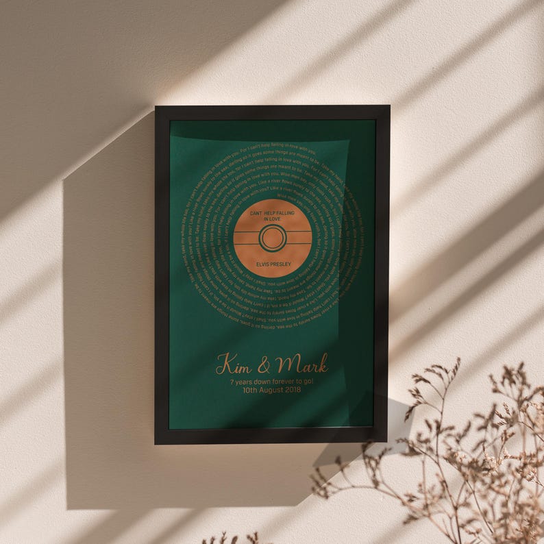 May include: Framed art print featuring a green background with a circular design resembling a vinyl record. The text "Can't Help Falling in Love" by Elvis Presley is displayed. The names "Kim & Mark" and the date "10th August 2016" are also visible.