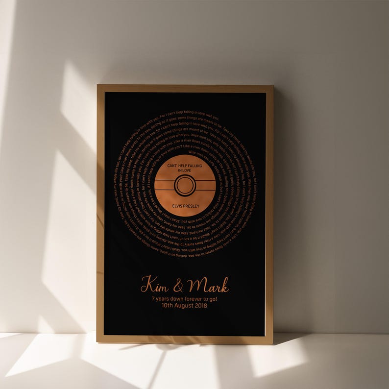 May include: Framed art print featuring a black background with a copper-colored vinyl record design. The record includes the lyrics to "Can't Help Falling in Love" by Elvis Presley. The names "Kim & Mark" and the date "10th August 2018" are also displayed.