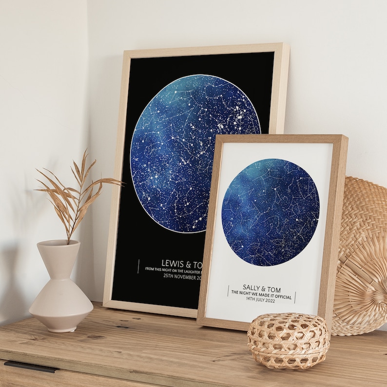 May include: Two framed star maps with blue and white constellations on a black and white background. The top frame has the text "LEWIS & TOM FROM THIS NIGHT ON THE LAUGHTER 25TH NOVEMBER 20". The bottom frame has the text "SALLY & TOM THE NIGHT WE MADE IT OFFICIAL 14TH JULY 2022".