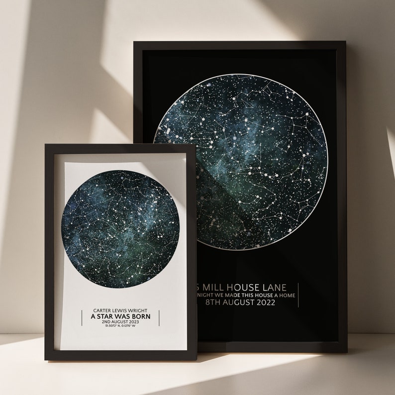 May include: Two black framed prints with a star map design. The smaller print has the text "CARTER LEWIS WRIGHT A STAR WAS BORN 2ND AUGUST 2023 51.5072&deg;N 0.009&deg;W". The larger print has the text "6 MILL HOUSE LANE NIGHT WE MADE THIS HOUSE A HOME 8TH AUGUST 2022".
