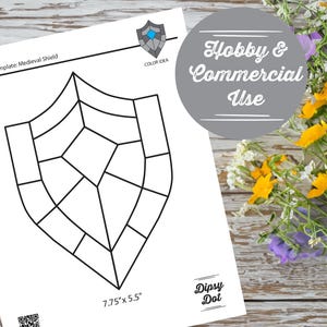 May include: A white paper template for a medieval shield design. The shield outline is black, with segmented interior lines. The text "Hobby & Commercial Use" is in a gray circle. The dimensions are 7.75" x 5.5".