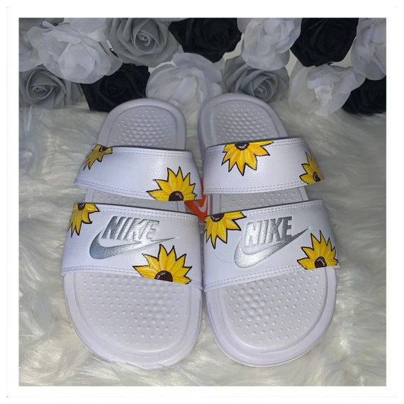 white sunflower nike slides