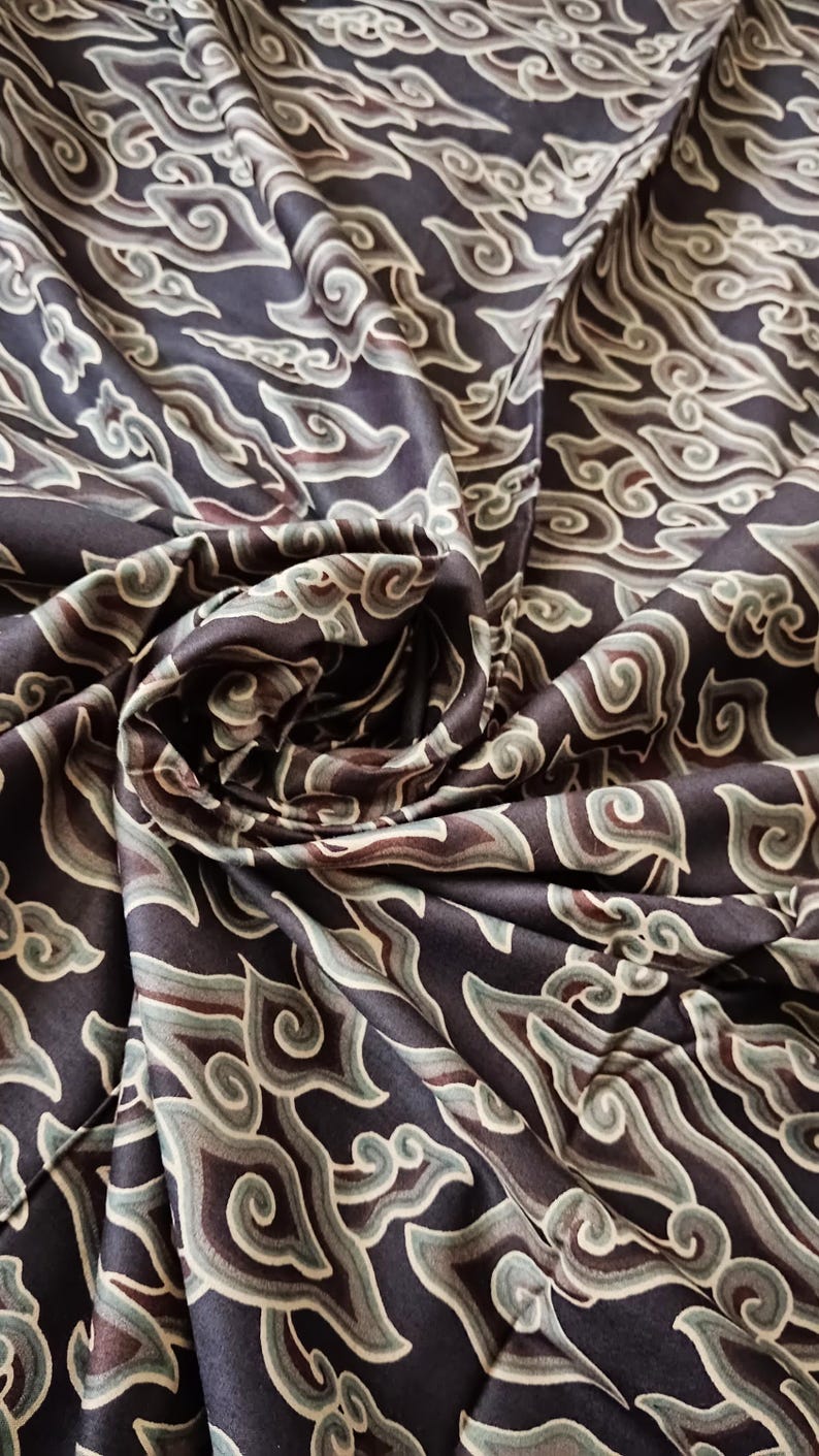 May include: Black fabric with a repeating pattern of stylized clouds in shades of brown, green, and white.