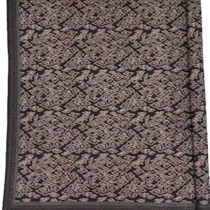 May include: A black fabric with a white and pink patterned design. The fabric is rolled up and has a border around the edges.