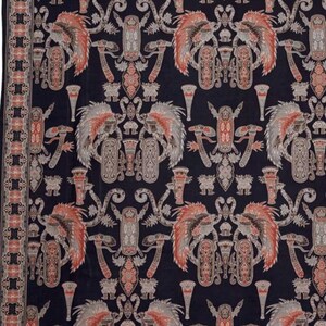 Könnte beinhalten: Dunkelmarinefarbenes Textil mit einem sich wiederholenden Muster aus stilisierten Figuren in Rot-, Grau- und Beigetönen. Das Design umfasst geflügelte Kreaturen und geometrische Formen mit einem detaillierten Rand.