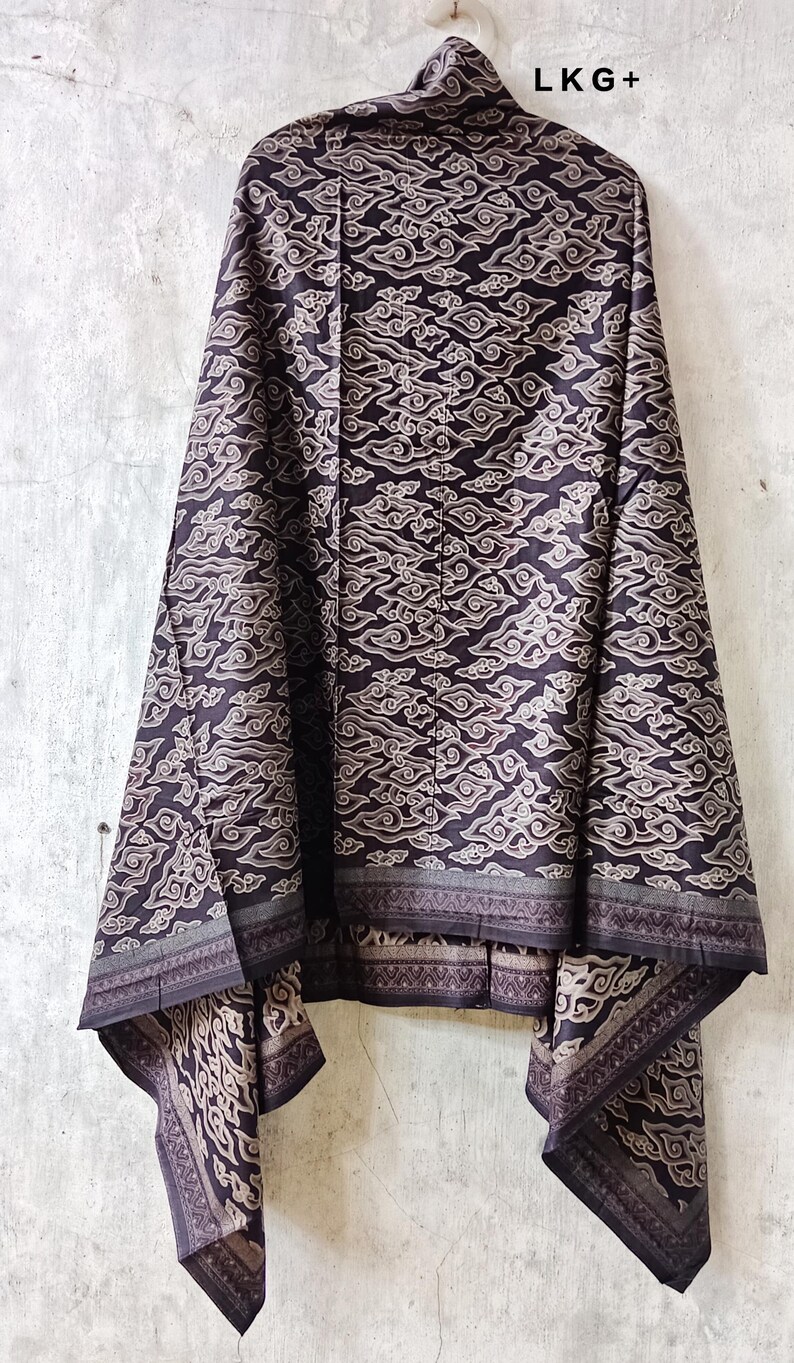 May include: Black and white batik fabric with a cloud pattern. The fabric has a border with a geometric design.