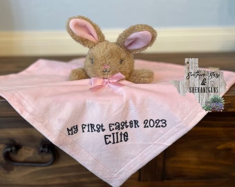 May include: Pink baby blanket with a brown bunny and the text "My First Easter 2023 Ellie" embroidered on it.