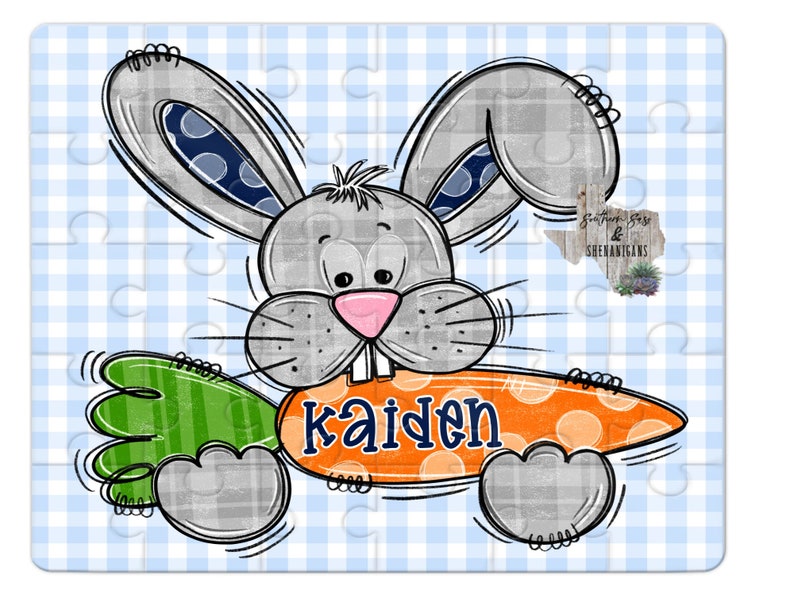 May include: A gray bunny rabbit with blue polka dots on its ears holds a large orange carrot with white polka dots and the name "Kaiden" written in blue letters.