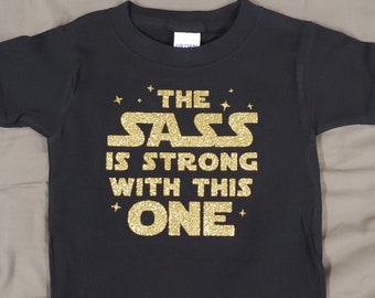 The Sass is Strong With This One- Black & Gold Funny Shirt for Any Kids of Star Wars fans!